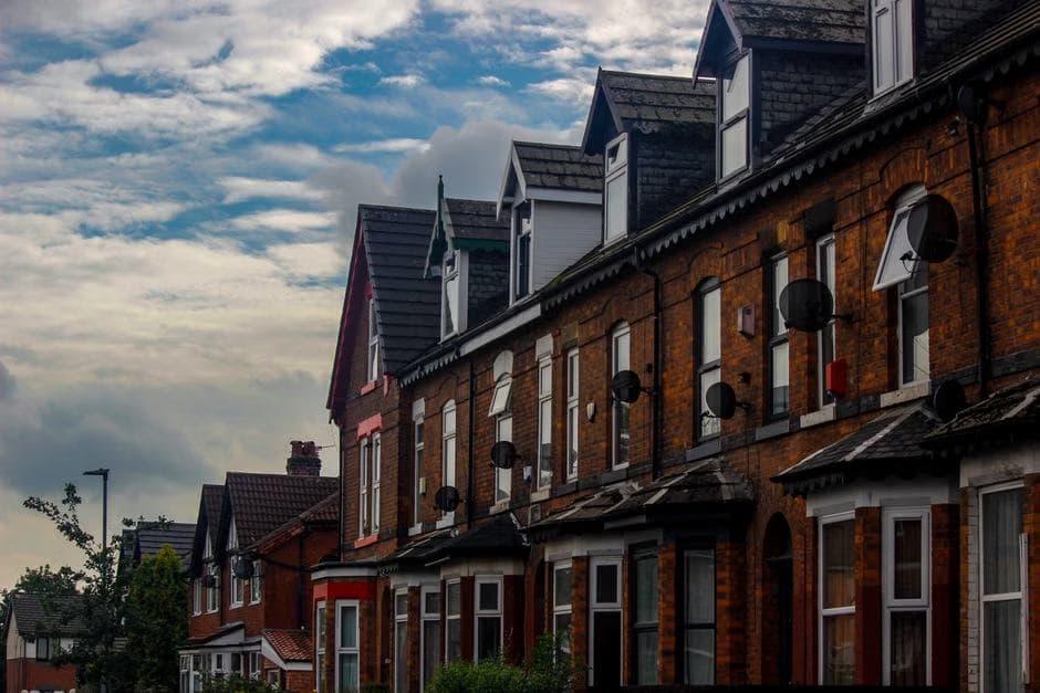 Red-brick terraced houses on a residential street