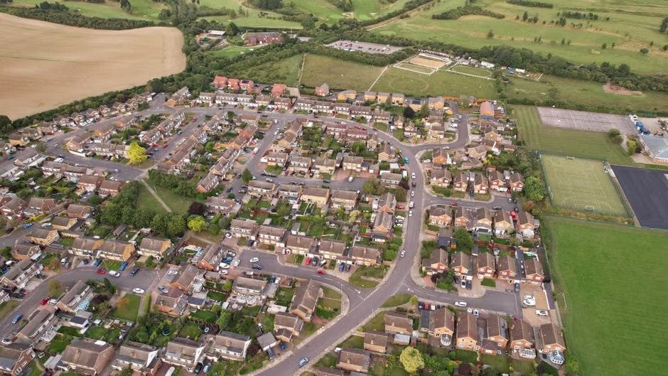 Aerial view of a UK housing estate surrounded by fields