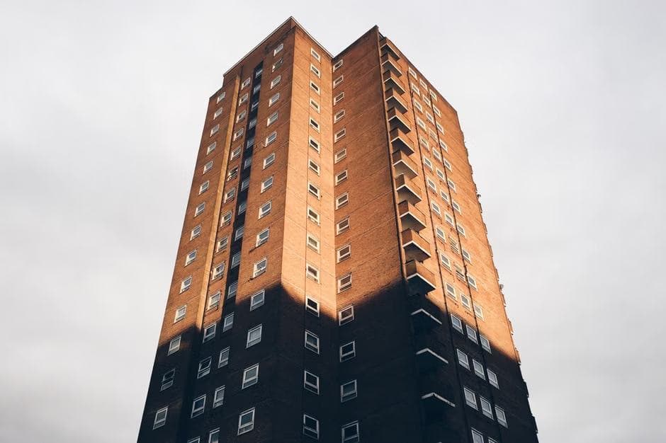 Brick tower block against a cloudy sky