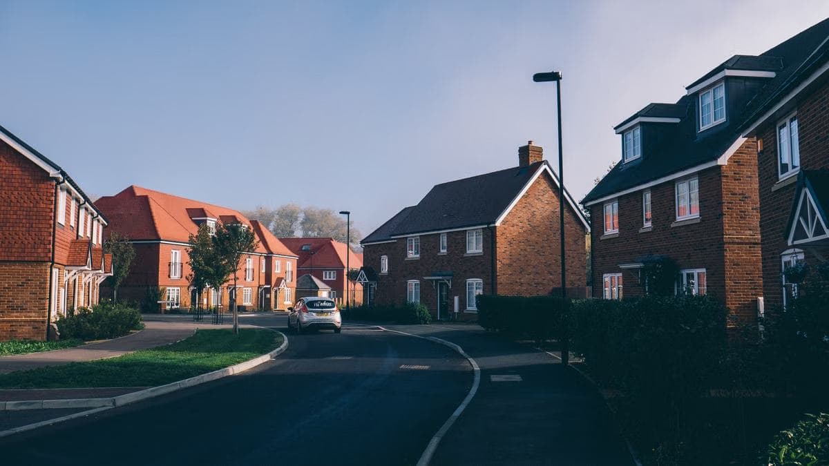 Modern red-brick homes along a quiet residential street